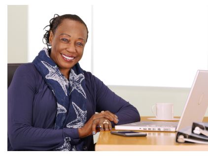 Smiling African-American woman sitting at a desk